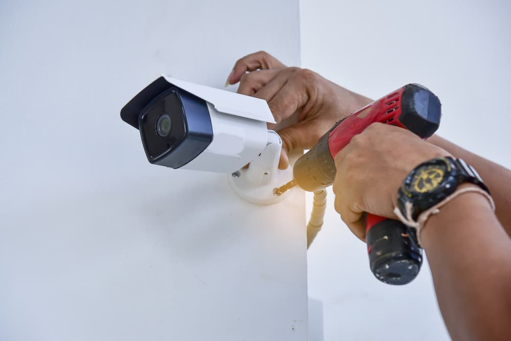 Brite MJ Technologies technician installing a CCTV camera on site